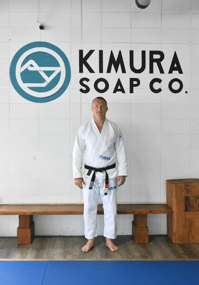 Christian standing in front of a 'Kimura Soap Co.' sign.