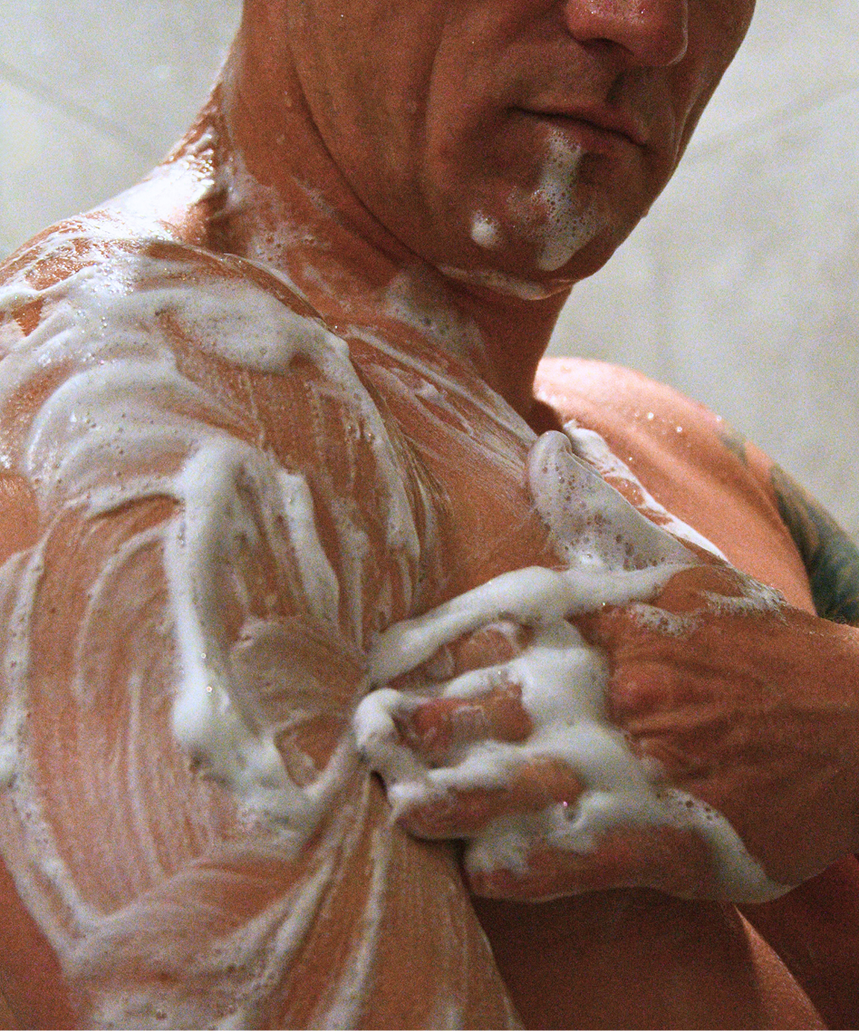 Man applying kimura soap to his skin 