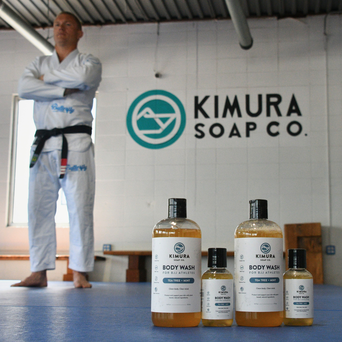 Christian standing in a dojo with Kimura Soap Co. products in front.