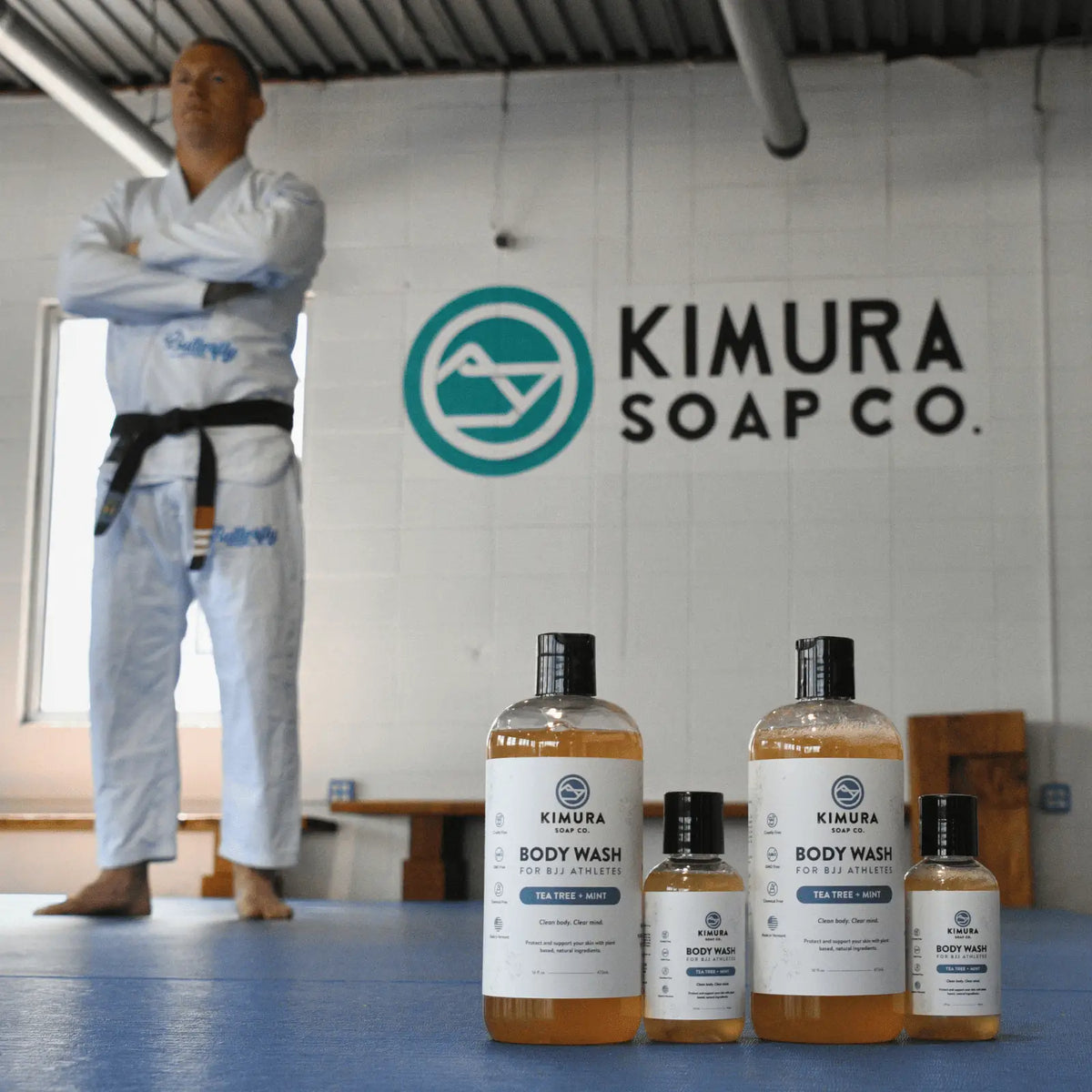 Christian standing in a dojo with Kimura Soap Co. products in front.