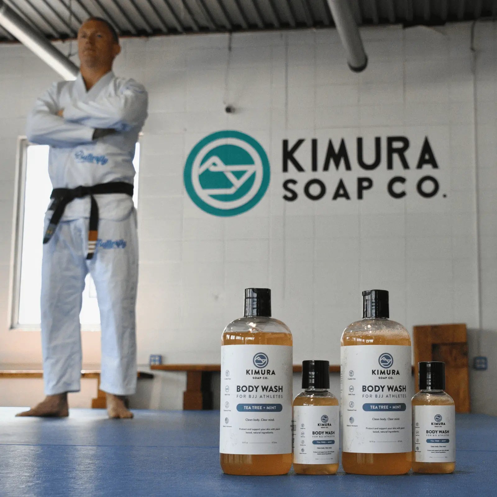 Christian standing in a dojo with Kimura Soap Co. products in front.